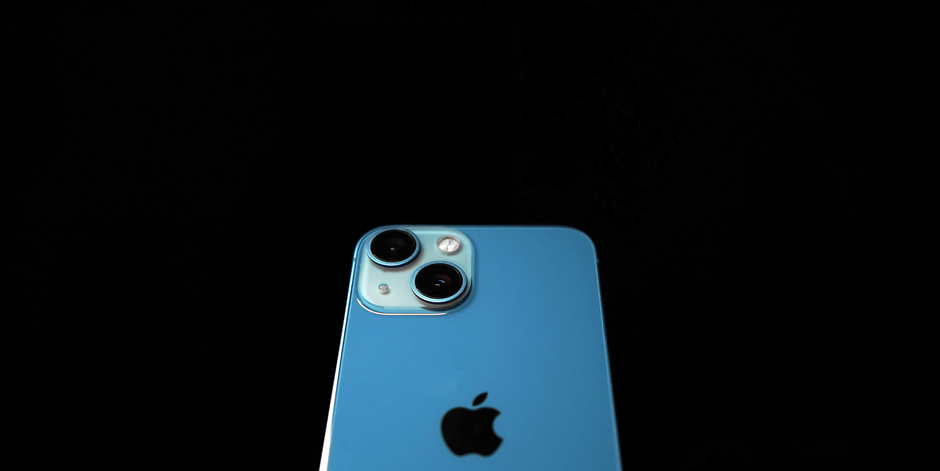 A sleek blue smartphone with dual cameras on a black background.